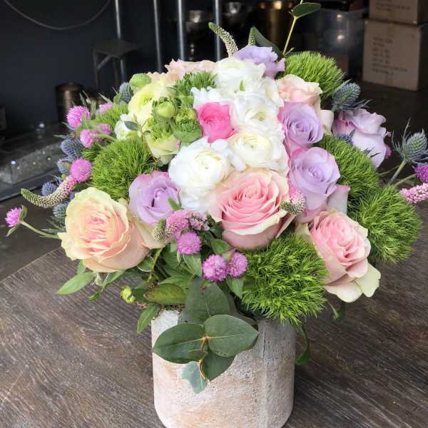 Pastel rose bouquet in a stone vase