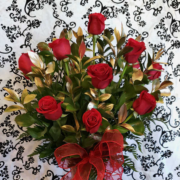 Bouquet of red roses in a glass vase with a red ribbon