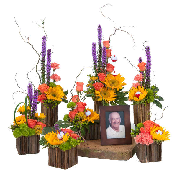 Set of rustic vased arrangements with sunflowers, roses, and fishing bobbers around a framed portrait.