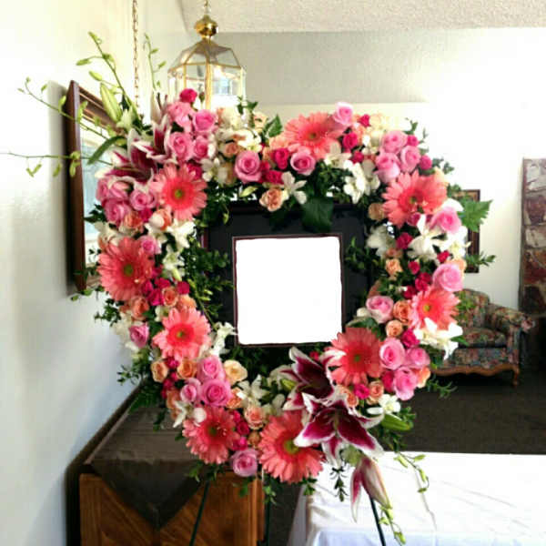 Heart-shaped floral wreath with pink roses and gerbera daisies