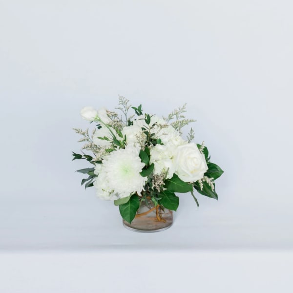 White floral arrangement in a clear glass vase