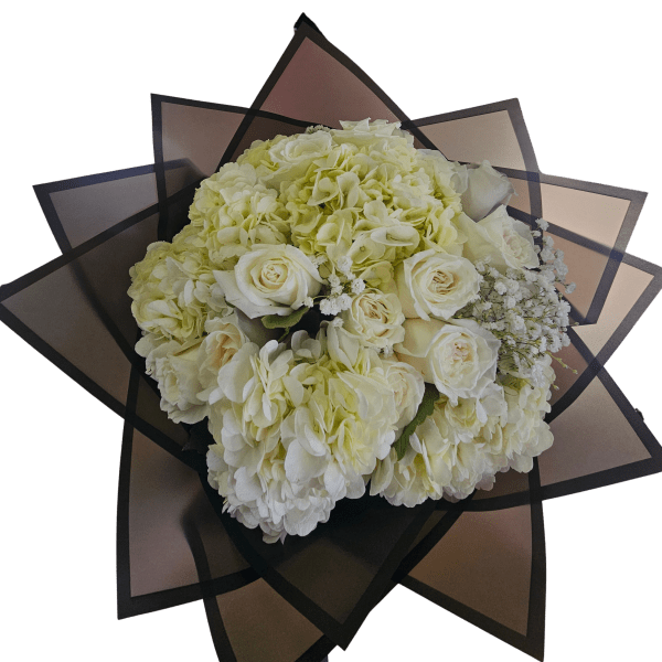 Round bouquet of ivory roses and hydrangeas wrapped in layered dark geometric paper