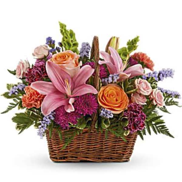 Basket of pink lilies, orange roses, and purple flowers