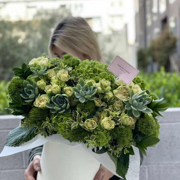 Large green bouquet with roses and succulents in a white box