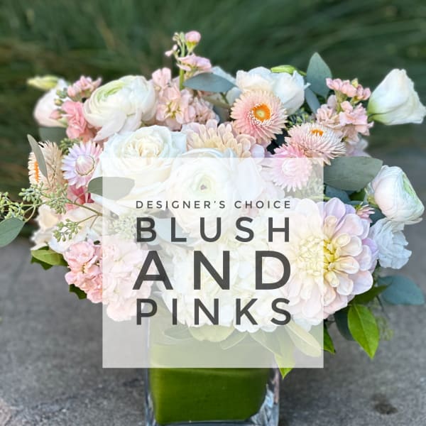 Blush and white mixed bouquet in a square glass vase