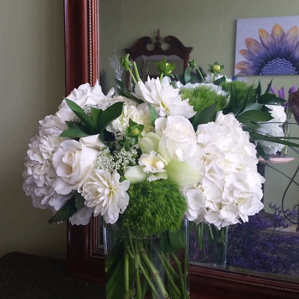 White floral arrangement in a clear glass vase