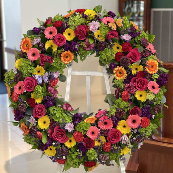 Large colorful floral wreath on a standing easel