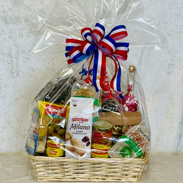 Gift basket with assorted snacks and chocolates wrapped in clear cellophane