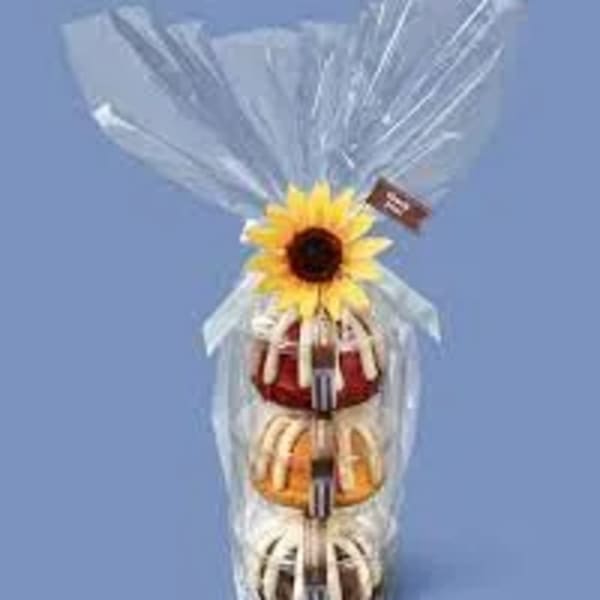 Gift tower wrapped in clear cellophane with a sunflower topper