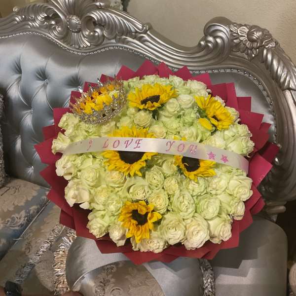 Bouquet of white roses and yellow sunflowers with a ribbon