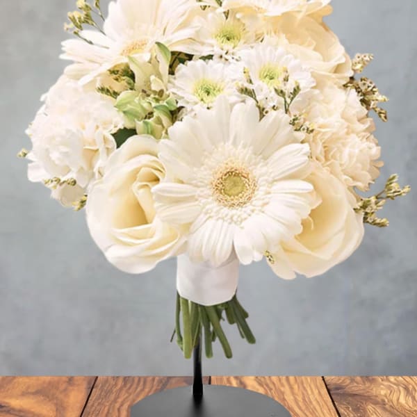 Cream bouquet of gerbera daisies and roses on a stand