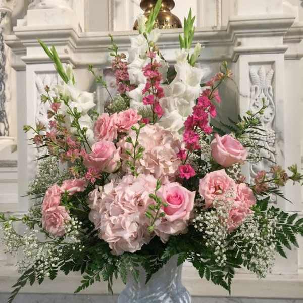 Pink and white floral arrangement in a glass vase