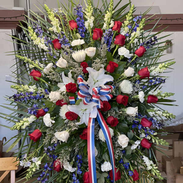 Large standing floral spray with red and white roses and white lilies