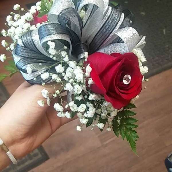 Small bouquet with a red rose, baby's breath, and silver ribbon loops