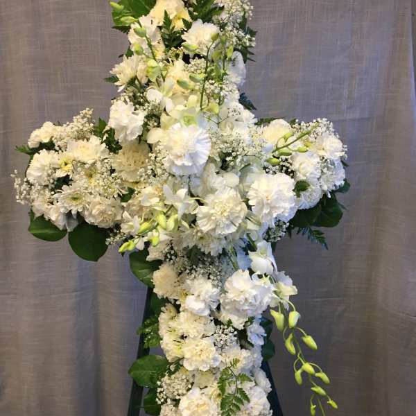Large white floral standing spray on an easel