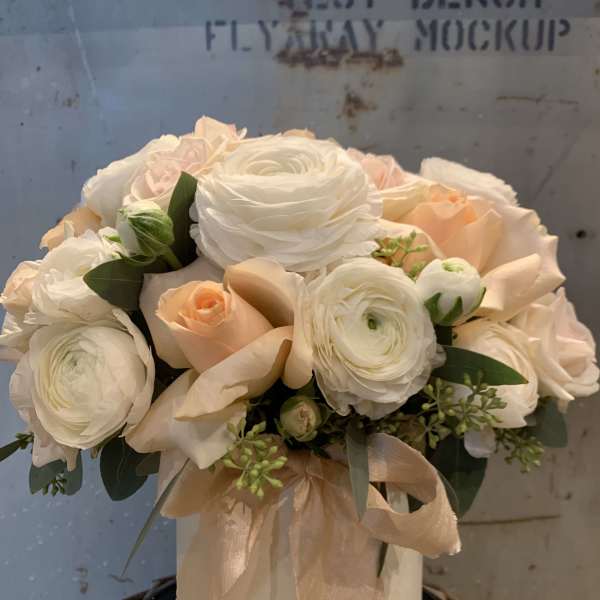 Cream and blush bouquet in a white hatbox with a ribbon