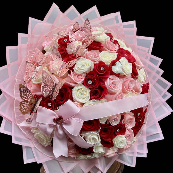 Pink and red rose bouquet with butterflies and a ribbon bow