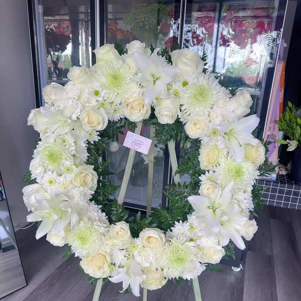 White floral wreath on a standing easel