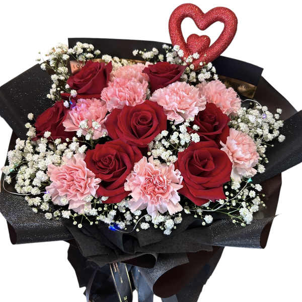 Bouquet of red roses and pink carnations with baby's breath