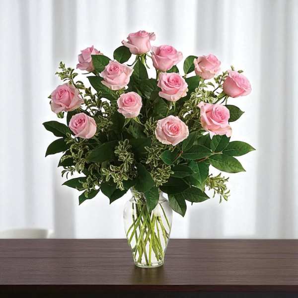 Pink roses arranged in a clear glass vase