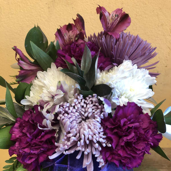 Purple and white mixed bouquet with a purple ribbon bow