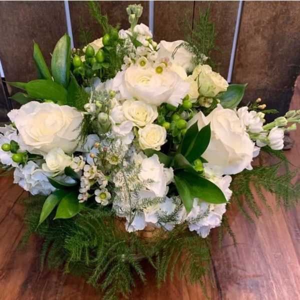 White rose bouquet with green accents and feathery foliage