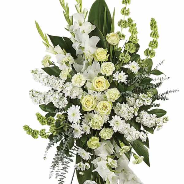 White and pale yellow funeral spray on a black easel