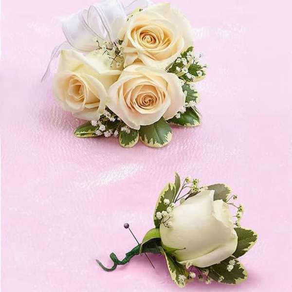 Cream rose boutonniere and matching rose corsage on a pink background