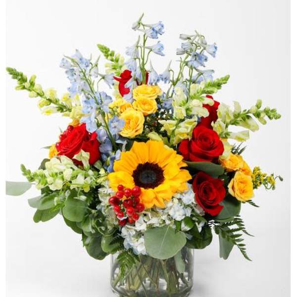 Mixed bouquet with red and yellow roses in a glass vase