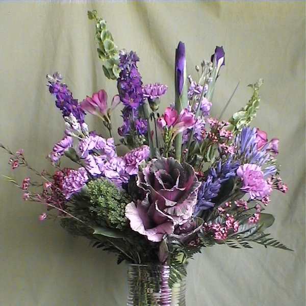 Purple and pink mixed bouquet in a clear glass vase