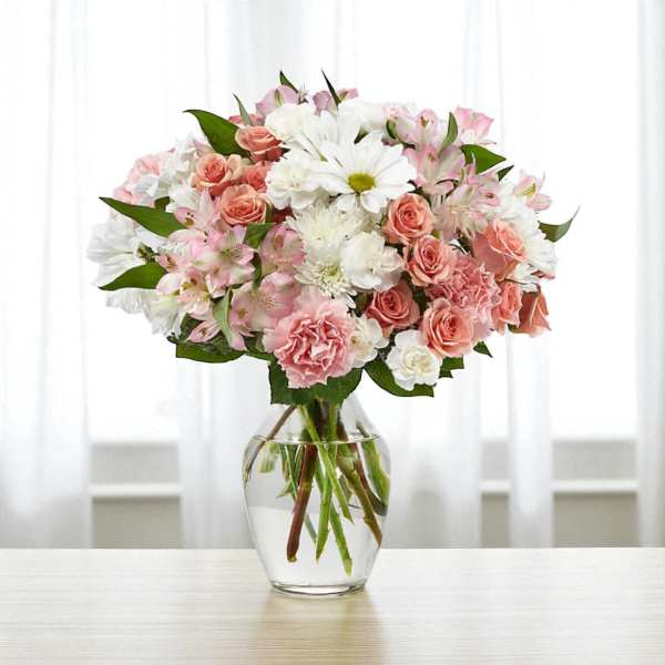Pink and white mixed bouquet in a clear glass vase