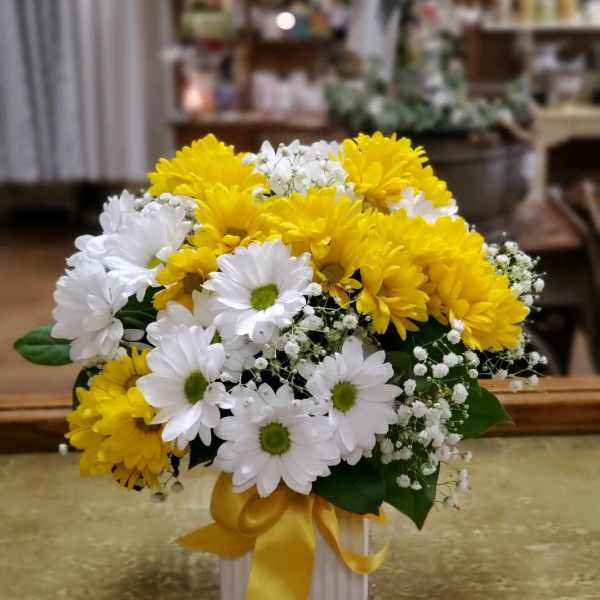 Yellow and white daisy bouquet in a white box with a yellow ribbon