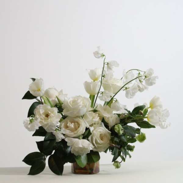 White floral arrangement in a low glass vase