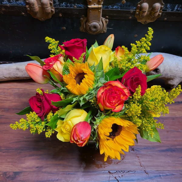 Bouquet of red and yellow roses with sunflowers and tulips