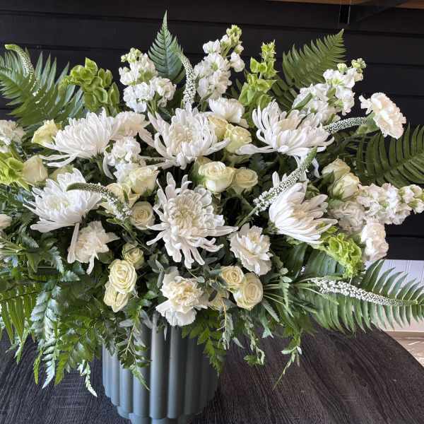 Large white floral arrangement in a gray vase