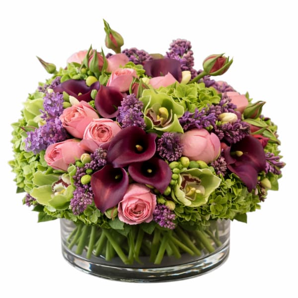 Pink roses and purple calla lilies in a glass vase