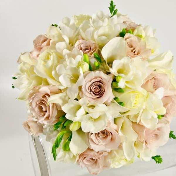 Bouquet of cream and blush flowers with green accents