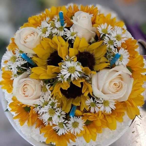 Round bouquet of yellow sunflowers, white roses, and small white daisies
