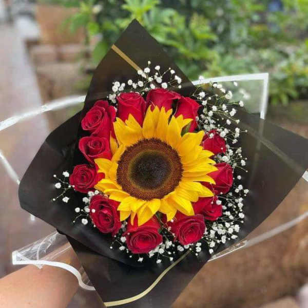 Bouquet of red roses with a sunflower and baby's breath in black wrap