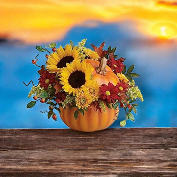 Pumpkin-shaped arrangement with sunflowers and red flowers