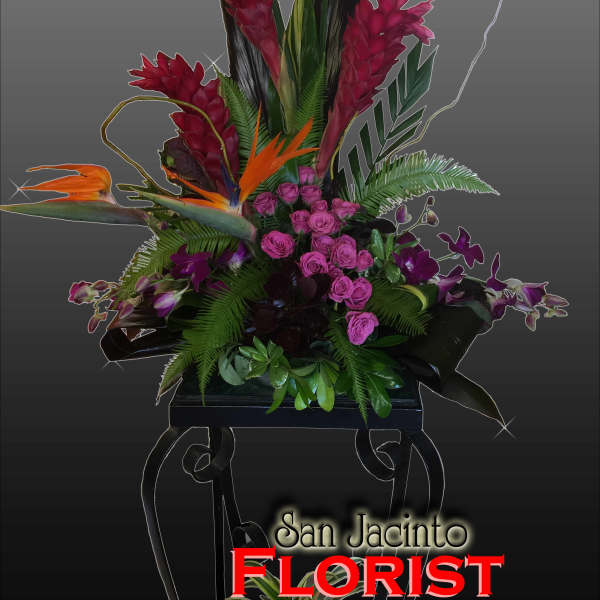 Tropical floral arrangement with pink roses and orange bird-of-paradise