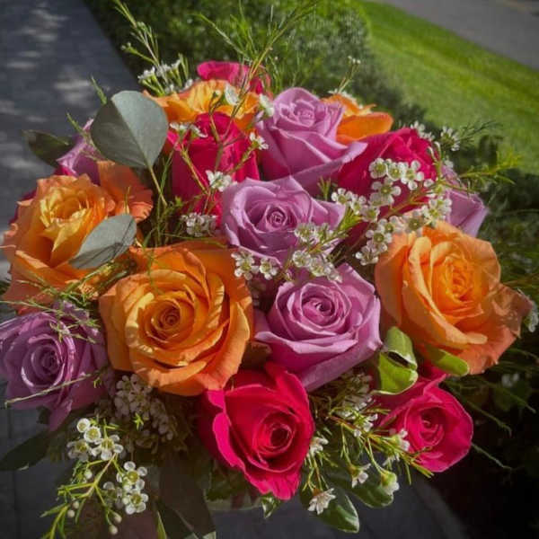 Bouquet of multicolored roses with small white filler flowers