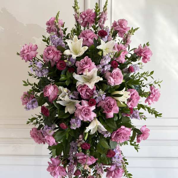 Large pink and white floral standing spray on an easel