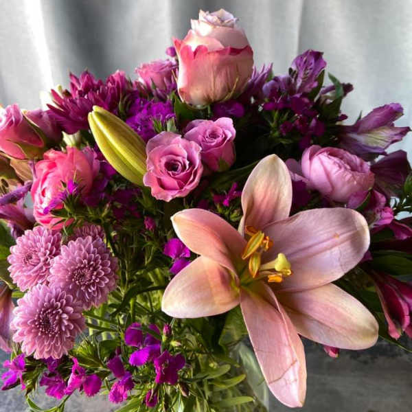 Bouquet of pink lilies, roses, and purple flowers