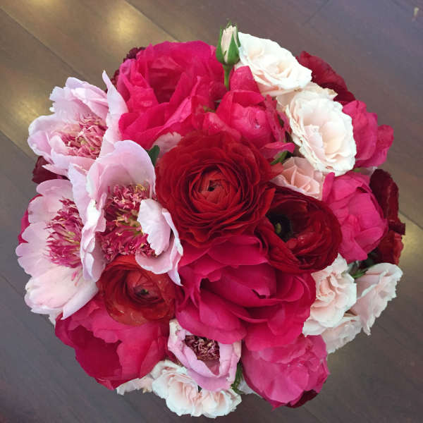 Round bouquet of pink, red, and white flowers
