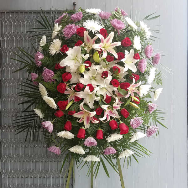 Large standing floral spray with red roses and white lilies