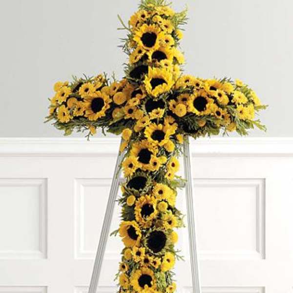 Yellow sunflower cross on a metal stand