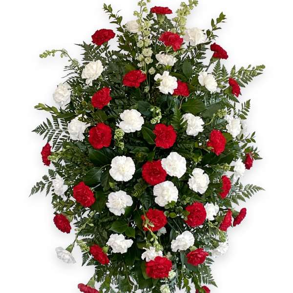 Standing floral spray with red and white carnations on an easel