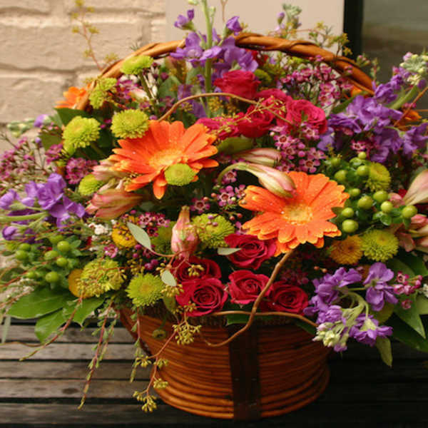 Colorful mixed flower basket with roses and gerbera daisies