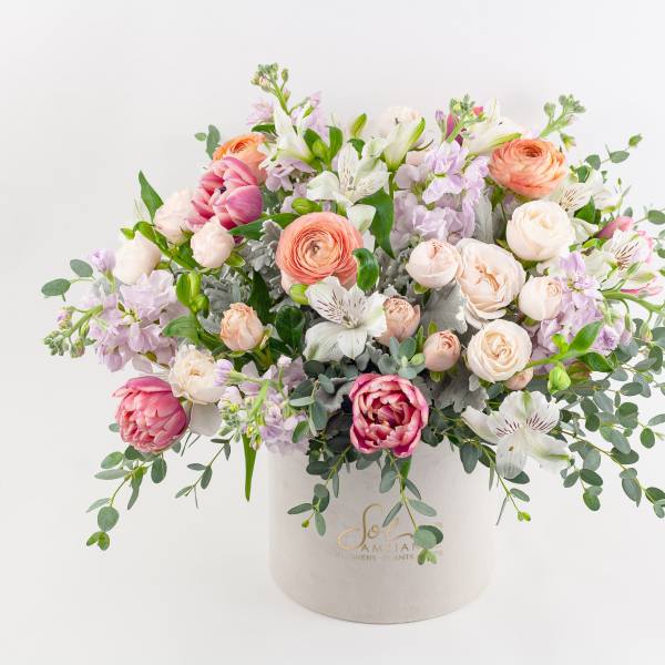 Mixed pastel bouquet in a white hatbox-style container